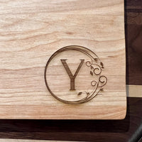 Detail image of the monogrammed board with an Y engraved into the bottom right
