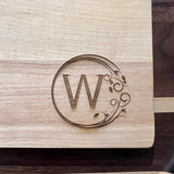 Detail image of the monogrammed board with an W engraved into the bottom right