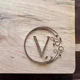 Detail image of the monogrammed board with an V engraved into the bottom right