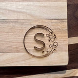 Detail image of the monogrammed board with an S engraved into the bottom right