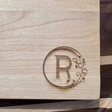 Detail image of the monogrammed board with an R engraved into the bottom right