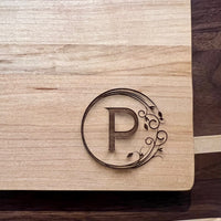 Detail image of the monogrammed board with an P engraved into the bottom right
