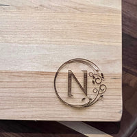 Detail image of the monogrammed board with an N engraved into the bottom right