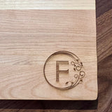 Detail image of the monogrammed board with an F engraved into the bottom right