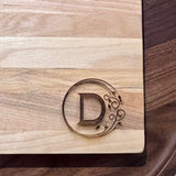 Detail image of the monogrammed board with an D engraved into the bottom right