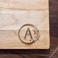 Detail image of the monogrammed board with an A engraved into the bottom right